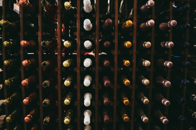 Close-up of wines stored horizontally in a wood wine rack
